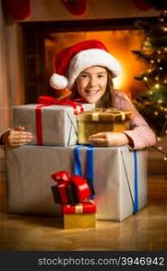 Portrait of cute smiling girl posing with Christmas presents