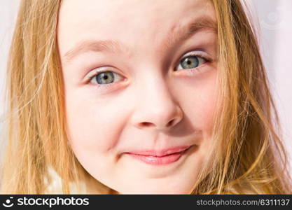 Portrait of cute smiling girl with blond hair