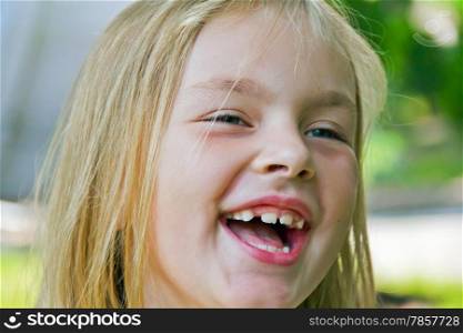 Portrait of cute smiling girl with blond hair