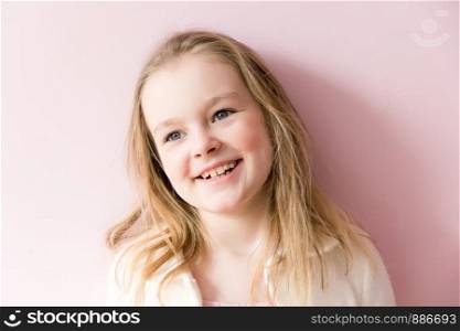 Portrait of cute smiling girl with blond hair