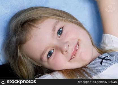 Portrait of cute toothless girl with blond hair