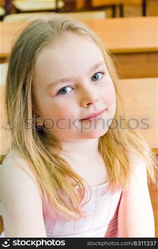 Portrait of cute younger schoolgirl with blond hair