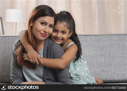 Portrait of daughter embracing her mother