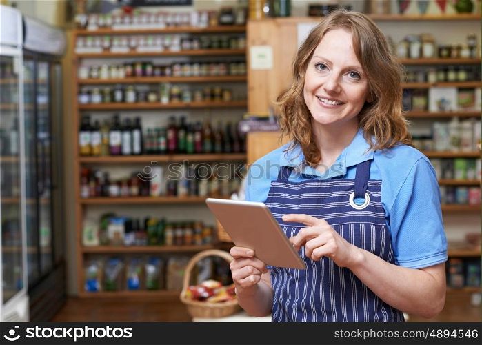 Portrait Of Delicatessen Owner With Digital Tablet