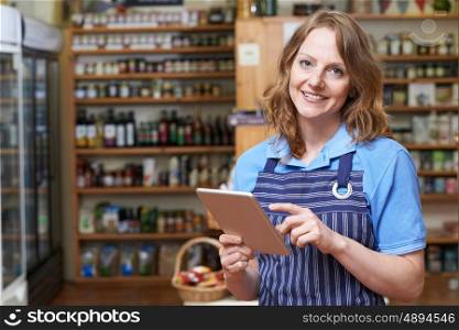Portrait Of Delicatessen Owner With Digital Tablet