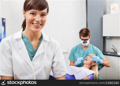 Portrait of dental assistant smiling with dentistry work in the background