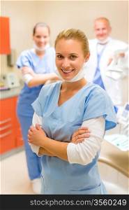 Portrait of dental team at modern surgery focus on nurse