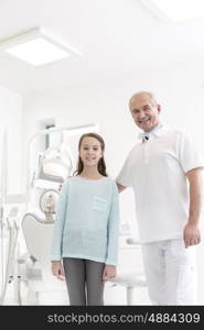 Portrait of dentist and girl patient at dental clinic