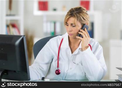 portrait of doctor in office using smartphone
