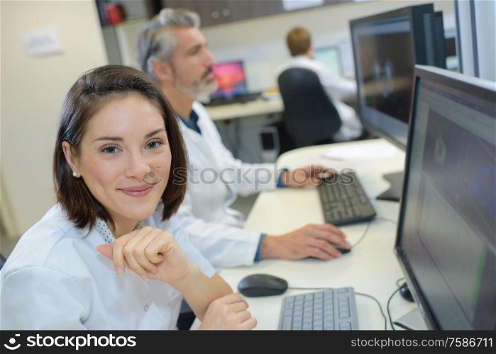 portrait of doctor looking at scans on computer