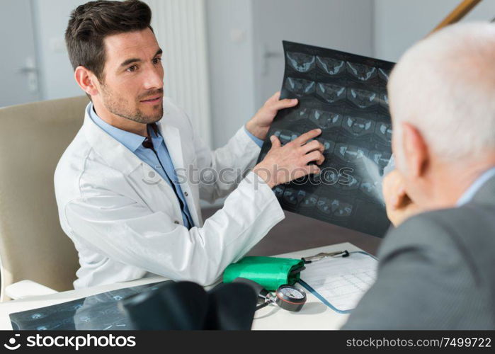 portrait of doctor showing patient xray