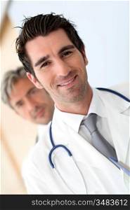 Portrait of doctor standing amongst medical team