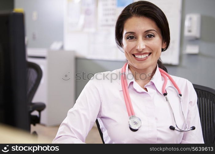 Portrait Of Doctor Working At Nurses Station