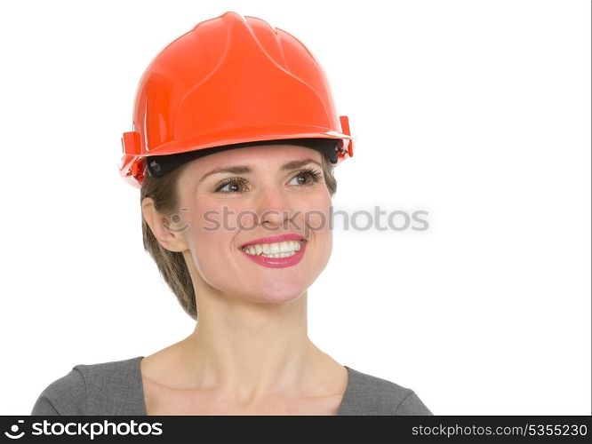 Portrait of dreaming architect woman in helmet. HQ photo. Not oversharpened. Not oversaturated. Portrait of dreaming architect woman in helmet isolated