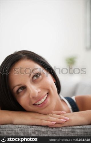 Portrait of dreaming girl laying on couch