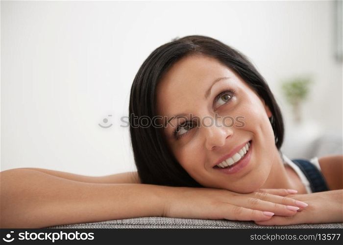 Portrait of dreaming girl laying on divan