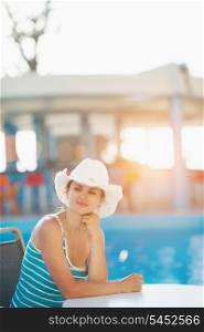 Portrait of dreaming woman at pool bar