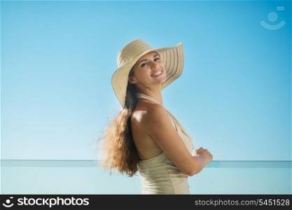 Portrait of dreaming woman standing on balcony and looking on copy space