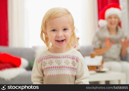 Portrait of eat smeared baby girl in Christmas enjoying Christmas