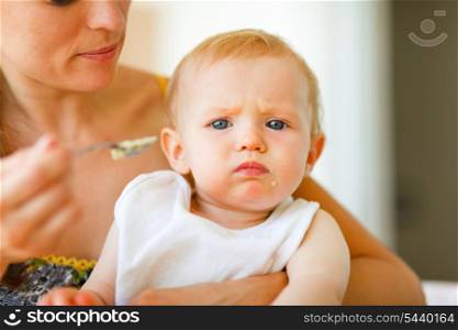 Portrait of eat smeared cute little baby feeding by mama&#xA;
