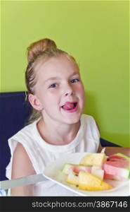 Portrait of eating girl with put out tongue