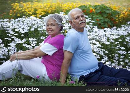 Portrait of elderly couple sitting in a park