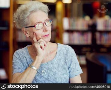 Portrait of elderly lady thinking something. Dreaming new project