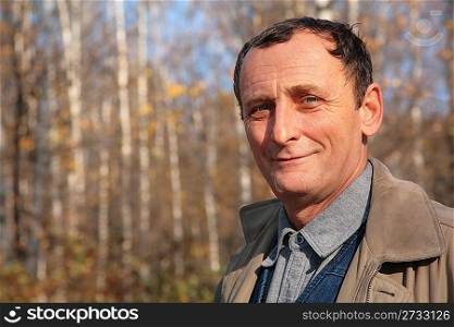 Portrait of elderly man in wood in autumn