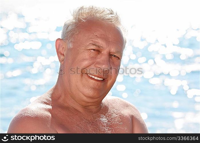 portrait of elderly smiling man on seacoast