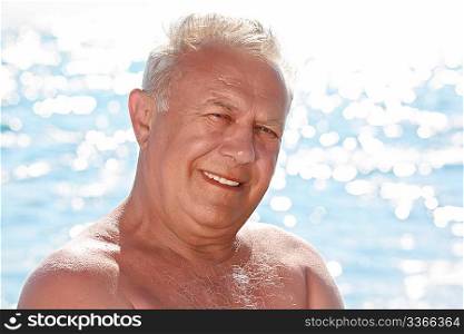 portrait of elderly smiling man on seacoast