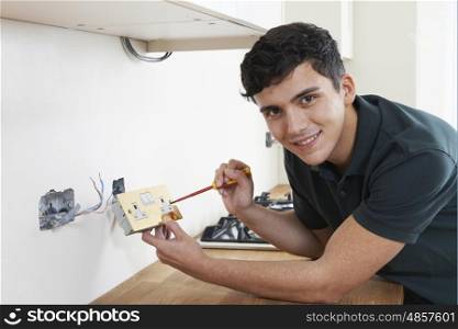 Portrait Of Electrician Installing Socket In New House