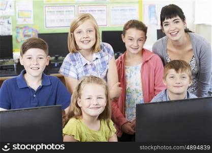 Portrait Of Elementary School Pupils With Teacher In Computer Class