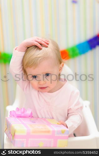 Portrait of embarrassed baby celebrating first birthday