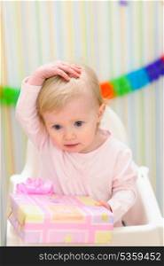 Portrait of embarrassed baby celebrating first birthday