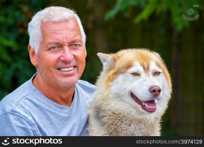 Portrait of european man with adult husky dog