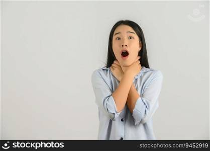 Portrait of Excited young asian woman in blue shirt hand on neck isolated on white background. Expression and lifestyle concept.