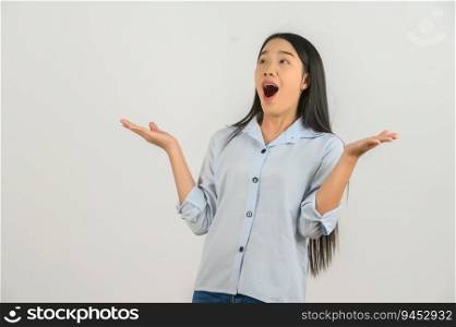 Portrait of Excited young asian woman in blue shirt hands up isolated on white background. Expression and lifestyle concept.