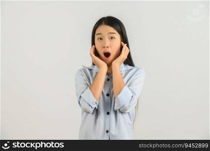 Portrait of Excited young asian woman in blue shirt looking at camera isolated on white background. Expression and lifestyle concept.