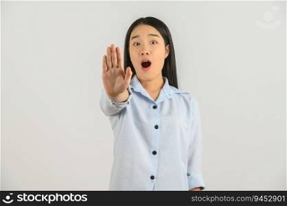 Portrait of Excited young asian woman in blue shirt showing hand foreground and looking at camera isolated on white background. Expression and lifestyle concept.