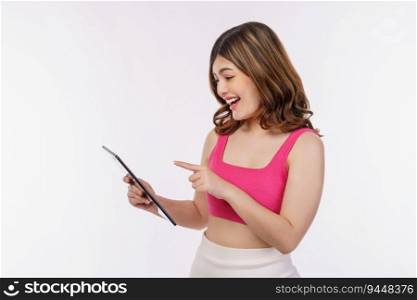 Portrait of excited young woman holding tablet isolated over white background. Technology, people and lifestyle concept.