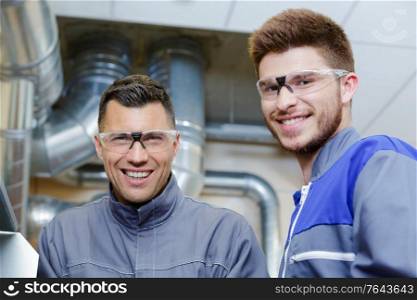 portrait of factory technicians smiling