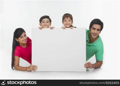 Portrait of family behind white board