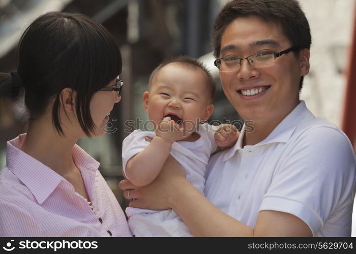 Portrait of family, father holding the baby, Beijing