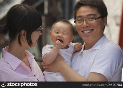 Portrait of family, father holding the baby, Beijing