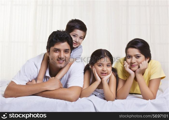 Portrait of family lying in bed