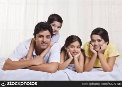 Portrait of family lying in bed