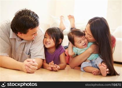 Portrait Of Family Lying On Floor At Home