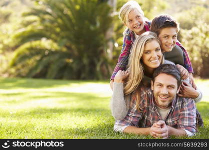 Portrait Of Family Lying On Grass In Countryside