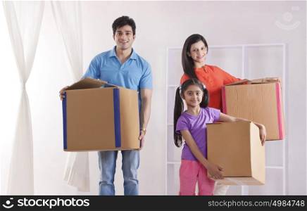 Portrait of family moving into new home
