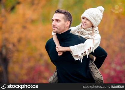 Portrait of family of father and little kid at beautiful autumn day outdoors.. Family of dad and kid on beautiful autumn day in the park